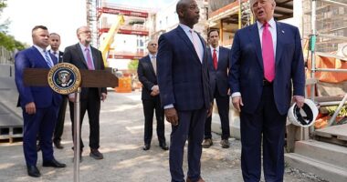 President Donald Trump speaks as Sen. Tim Scott, R-S.C., in foreground left, and from background left, Bill Pulte, director of the Federal Housing Finance Agency, White House staff secretary Will Scharf, Russell Vought, director of the Office of Management and Budget, White House Deputy Chief of Staff James Blair and Mark Paoletta, general counsel with the Office of Management and Budget, listen as Trump visits the Federal Reserve, Thursday, July 24