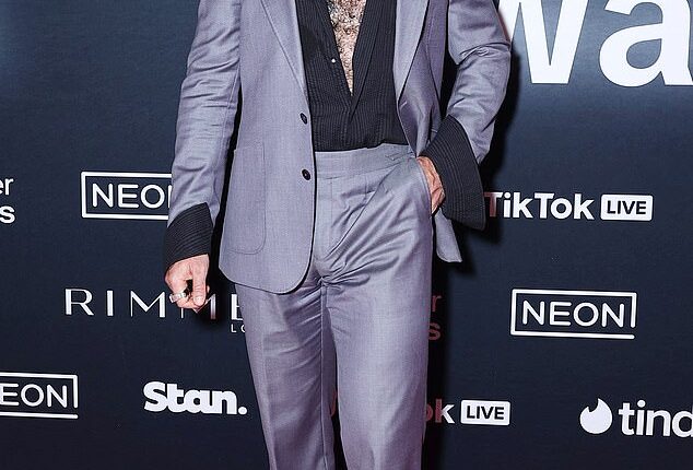 Adam Hyde, 35, made a bold entrance in a grey suit paired with an unbuttoned black shirt that revealed his signature chest hair and torso tattoo. (Pictured)