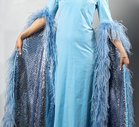 Cilla Black's iconic velvet ballgown is tried on by Daily Mail news reporter Katherine Lawton (pictured). Price at auction: £350-£550