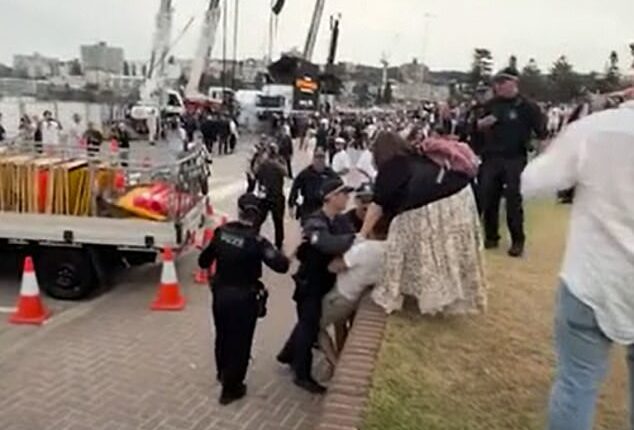 A man was told to leave Bondi Beach after running towards Prime Minister Anthony Albanese and screaming 'blood on your hands'