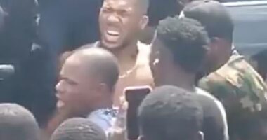 Anthony Joshua pictured after the car crash in Nigeria on Monday which killed two people. The Champion boxer came within inches of death in the crash