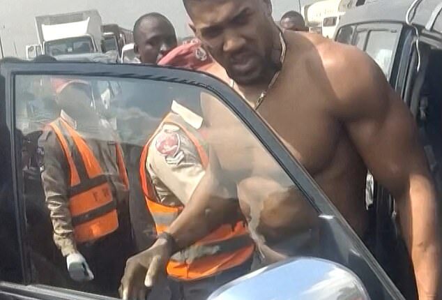 Anthony Joshua being moved from a Lexus after a car crash in Nigeria. He escaped death on Nigeria's deadliest road where 73 people have died in just three months