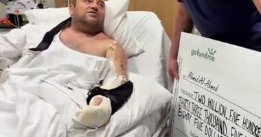 Pictured is the moment Mr Al-Ahmed was handed a $2.5million cheque in hospital
