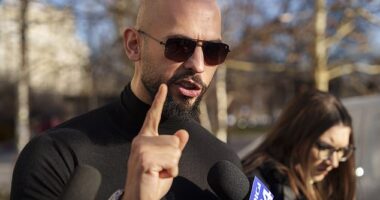 Research shows four out of ten young men hold a positive view of sexist commentators such as Andrew Tate, pictured outside the Bucharest Tribunal in Romania