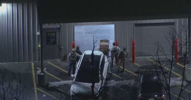 Armed police officers gathered outside of a storage facility in Salem, New Hampshire on Thursday, where a vehicle that was rented to the man suspected of opening fire at Brown University was found