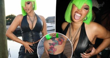 Cardi B shows off new neck and back dermal piercings in plunging second-skin leather look