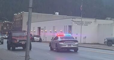 Pictured: There is a heavy police presence outside the Shoshone County Sheriff’s Office in Wallace, Idaho. Authorities have confirmed there is an active shooter situation