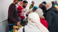 Douglas Luiz (centre) helps out at the Salaam Shalom Kitchen in Nottingham that provides free hot meals to those in need every Wednesday. ‘It’s a special day,' he says, 'because sometimes you need to see real life'