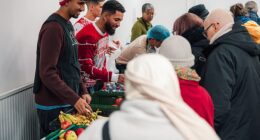 Douglas Luiz (centre) helps out at the Salaam Shalom Kitchen in Nottingham that provides free hot meals to those in need every Wednesday. ‘It’s a special day,' he says, 'because sometimes you need to see real life'