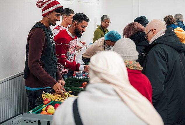 Douglas Luiz (centre) helps out at the Salaam Shalom Kitchen in Nottingham that provides free hot meals to those in need every Wednesday. ‘It’s a special day,' he says, 'because sometimes you need to see real life'