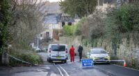 Roads were closed on Brimscombe Hill after police investigated the cause of a house fire that is believed to have killed three and hospitalised one person