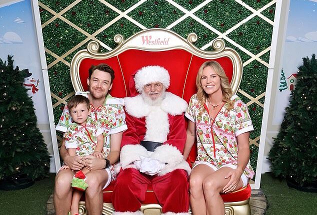 Emily Seebohm has clapped back after a troll slammed her for allowing her son, who she shares with her ex Ryan Gallagher, to sit on the lap of her new partner in a family Christmas photo with Santa. Pictured: Emily's son Sampson and her new boyfriend, Brandon Caust