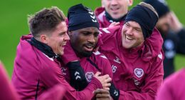Cammy Devlin, Elton Kabangu and Blair Spittal share a joke in Hearts training