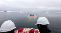 China's research submarines traversed thousands of feet beneath the ice for the first time over the summer. Its manned deep-sea submersible Jiaolong is pictured returning to the surface from the bottom of the sea in the Arctic Ocean on August 6