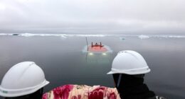 China's research submarines traversed thousands of feet beneath the ice for the first time over the summer. Its manned deep-sea submersible Jiaolong is pictured returning to the surface from the bottom of the sea in the Arctic Ocean on August 6
