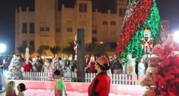 Under a sea of twinkling lights, children frolic in snow and penguins waddle around a marching band of Candy Cane men playing festive tunes