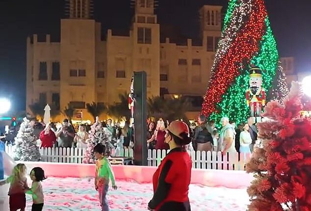 Under a sea of twinkling lights, children frolic in snow and penguins waddle around a marching band of Candy Cane men playing festive tunes