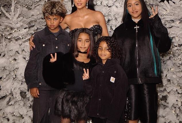 Kim Kardashian, 45, shared a rare portrait with all four of her children for memorable Christmas snaps - but there was no sign of her ex-husband Kanye West