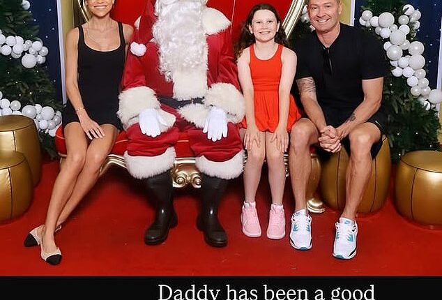 Michael Clarke has raised eyebrows after he appeared to make a cheeky comment while posing for a festive family photo with daughter Kelsey Lee and girlfriend Arabella Sherborne at a local Westfield shopping centre
