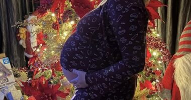 Pregnant Perrie Edwards, 32, cradled her baby bump as she posed for gorgeous Christmas snaps in front of her tree