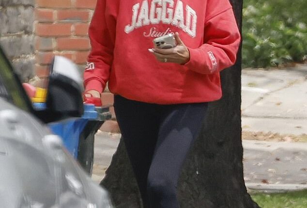 Jo Silvagni takes out the trash outside the home where her rapist son committed his vile crimes