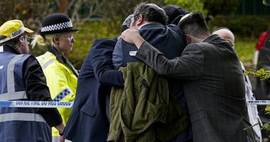 Members of the Jewish community comfort each other outside the Heaton Park Hebrew Congregation synagogue. In the wake of the October terror attack, the government will provide an extra £10million to guarantee the safety of the Jewish community