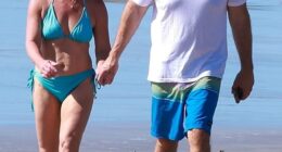 Congresswoman Marjorie Taylor Greene and her fiancé Brian Glenn appeared happy and relaxed as they walked hand-in-hand down along the beach on Christmas Day