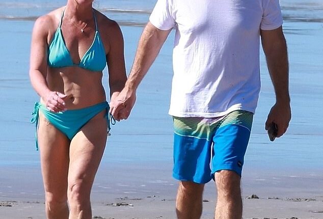 Congresswoman Marjorie Taylor Greene and her fiancé Brian Glenn appeared happy and relaxed as they walked hand-in-hand down along the beach on Christmas Day