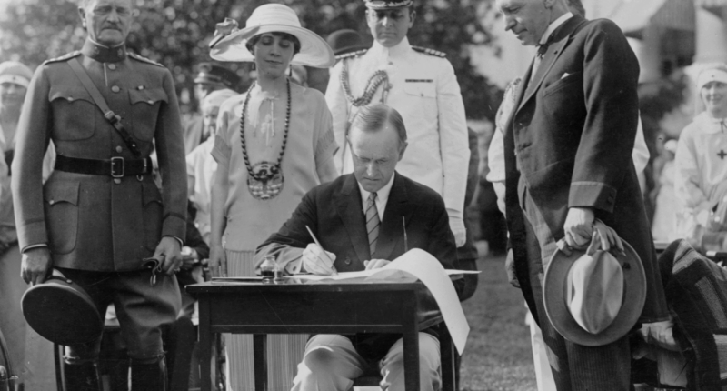Calvin Coolidge signing legislation