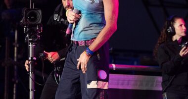 Chris Martin wearing one of his signature tie-dyed t-shirts for his performance at Glastonbury in summer 2024