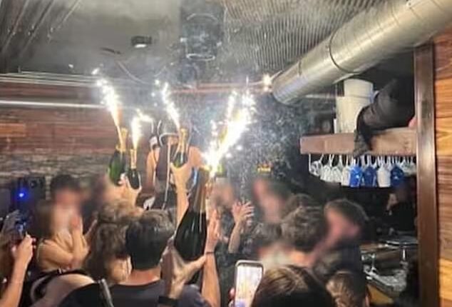 A photo appears to show the moment champagne sparklers set fire to material on the ceiling of the Swiss nightclub