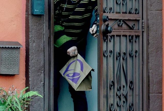 A bald Mickey Rourke looked unrecognizable as he emerged from the LA home he is potentially facing eviction from after allegedly failing to pay nearly $60,000 in rent