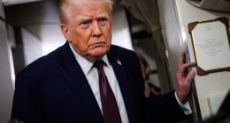 Donald Trump takes questions from the members of the press aboard Air Force One en route back to the White House on January 11