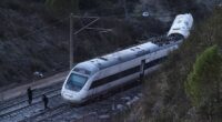 Members of the Spanish Civil Guard work next to one of the trains involved in the accident, at the site of a deadly derailment of two high-speed trains near Adamuz, in Cordoba, Spain, January 19, 2026