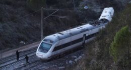 Members of the Spanish Civil Guard work next to one of the trains involved in the accident, at the site of a deadly derailment of two high-speed trains near Adamuz, in Cordoba, Spain, January 19, 2026