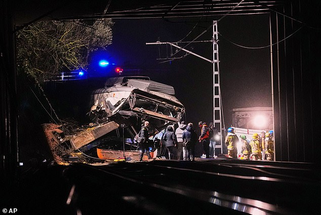 Emergency crews respond after a commuter train derailed when a retaining wall collapsed onto the tracks in Gelida, near Barcelona, Spain, on Tuesaday