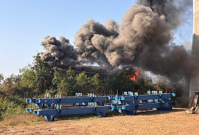 Smoke billowing from the wreckage of a passenger train after a construction crane collapsed onto it in Sikhio district, Nakhon Ratchasima, Thailand, 14 January 2026