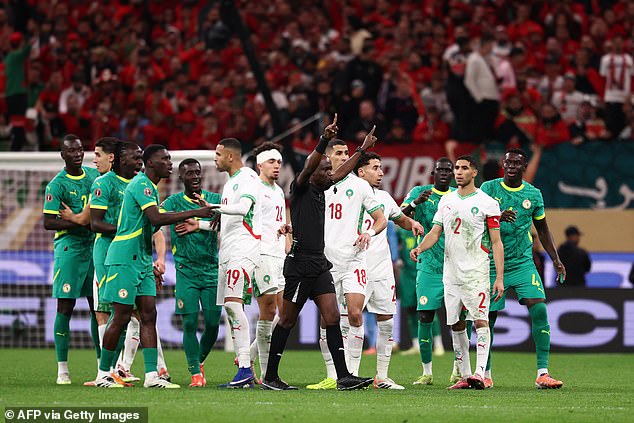 AFCON final descends into CHAOS as Senegal boss calls his team off the pitch after controversial late penalty is awarded to Morocco by VAR
