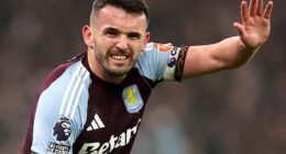 John McGinn calls for help after injuring his knee during Aston Villa's defeat to Everton
