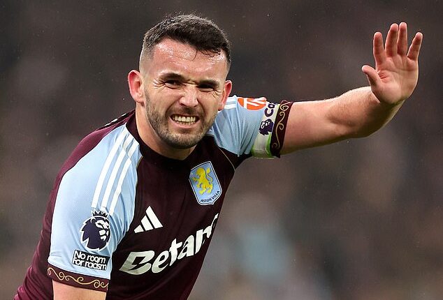 John McGinn calls for help after injuring his knee during Aston Villa's defeat to Everton