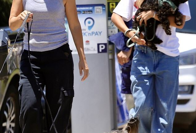 Bec Hewitt looked in good spirits as she stepped out for a stroll on Bondi Beach with her daughter Ava on Monday. Both pictured