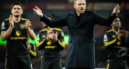 Michael Carrick celebrates in front of the Man United fans - and his children - at Arsenal