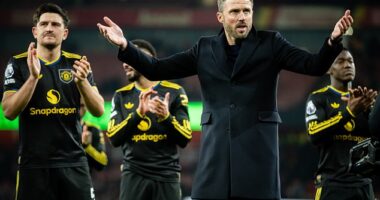 Michael Carrick celebrates in front of the Man United fans - and his children - at Arsenal