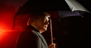 Donald Trump under an umbrella