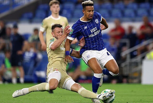 Swindon Town footballer, Ollie Clarke (left), pictured in the game against Cardiff in which the incidents took place last August. There is no suggestion Cardiff player Callum Robinson (right) was one of the opponents affected by Clarke's behaviour