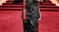 Pajama vibes! Snoop Dogg looked like he was going to an entirely different even as he sported a black satin suit on the Globes red carpet. The suit featured red stripe detailing on the blazer and side of his pants. He completed the look with a shiny black pair of dress shoes