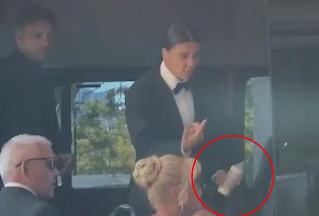 Sam Kerr is pictured holding a baby bottle for her baby son Jagger as she prepares to leave for her wedding ceremony on New Year's Eve