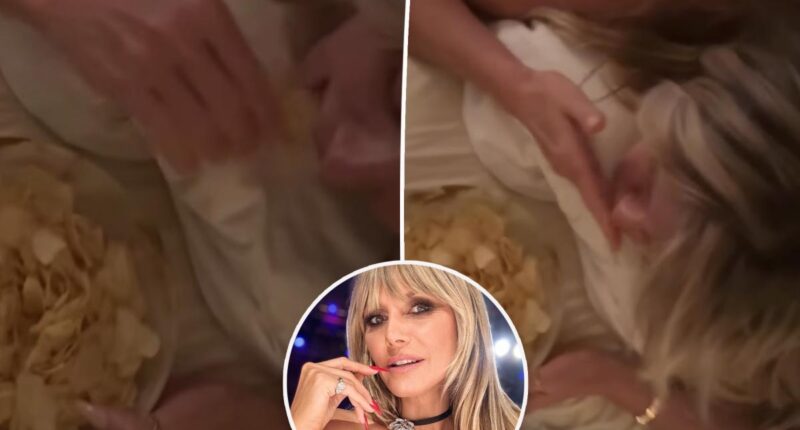 Heidi Klum gets a butt massage while eating potato chips
