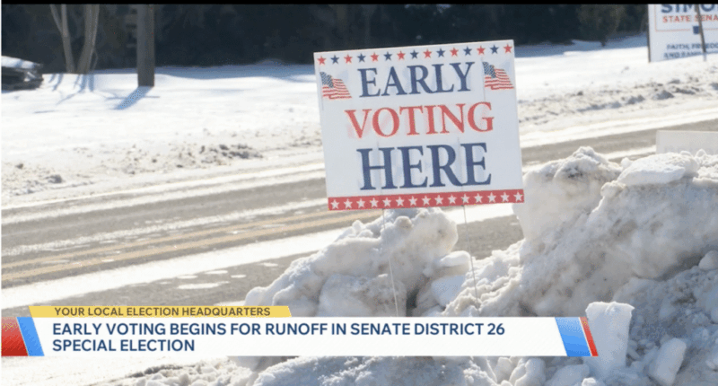 An early voting sign in the snow on election day.