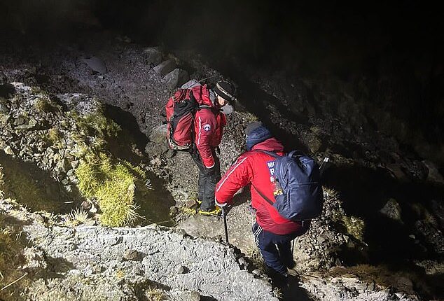 A mountain rescue team helped two young men who became stuck on Scafell Pike in 'treacherous conditions'